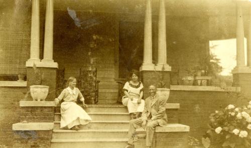 Image of unidentified family sitting on a porch